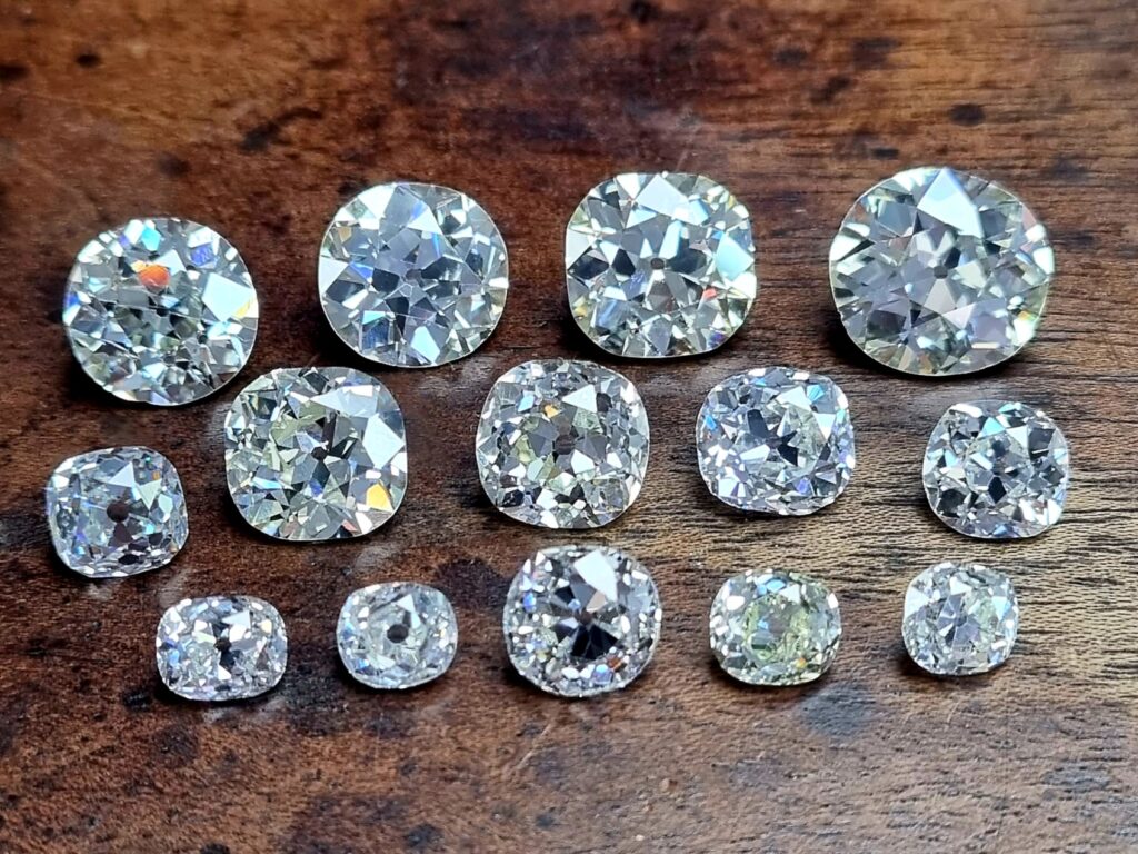 14 antique diamonds lying on a wooden background