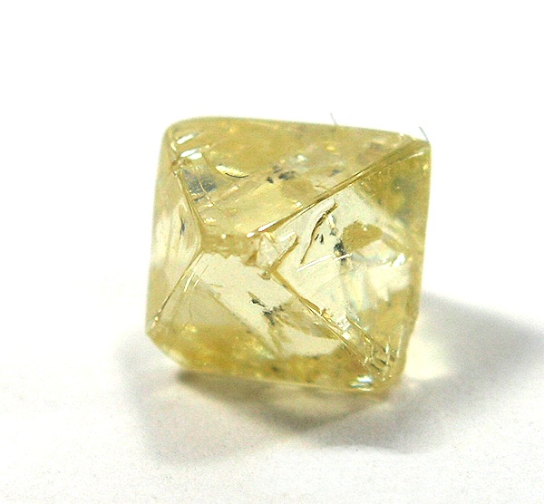 A yellow octahedral rough diamond crystal