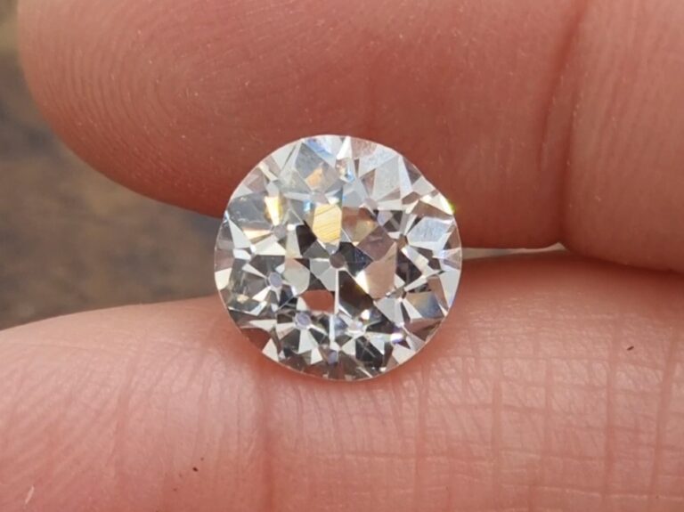 A 4.50 carat old European cut diamond held between fingers