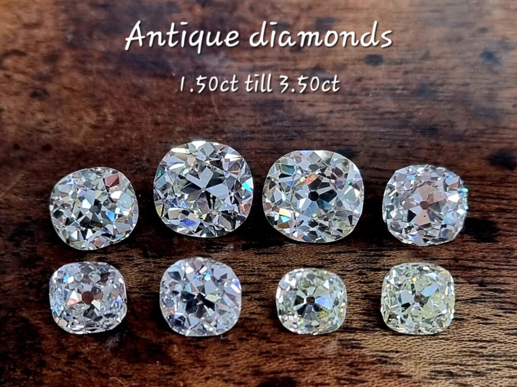 8 old mine cut diamonds  ranging from 1.5ct until 3.50ct. On a wooden background