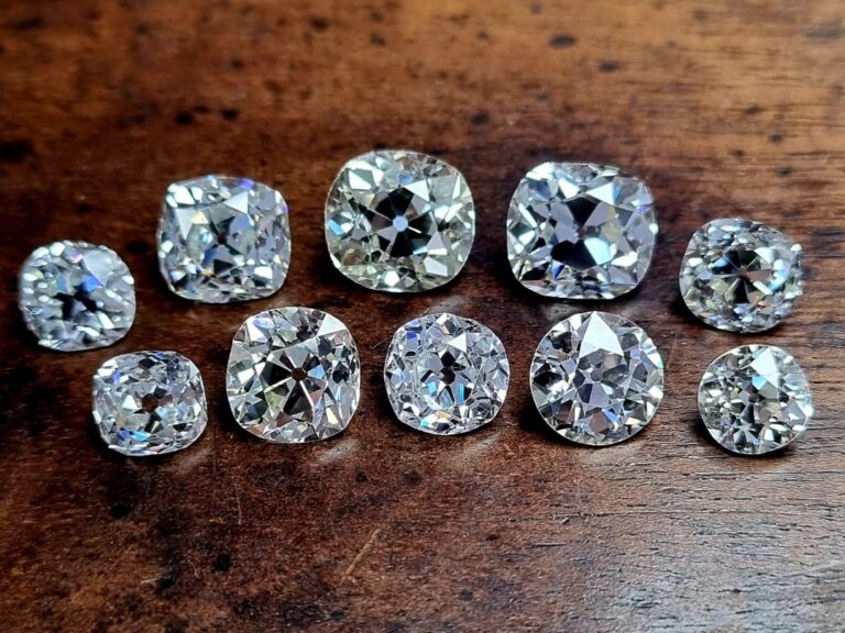 10 old mine cut diamonds on a wooden background