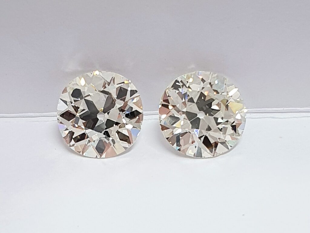 A pair of old European cut diamonds on a white background